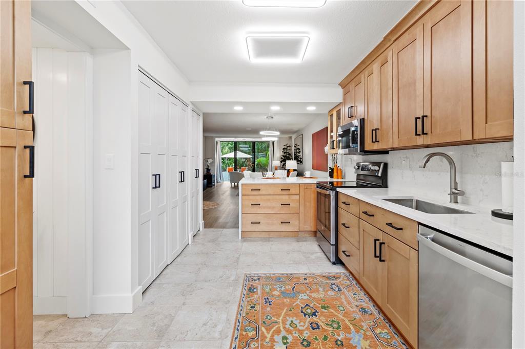 806 Bayport Way, Unit 806 Longboat Key, FL 34228 - Photo 13 of 79 a kitchen with stainless steel appliances granite countertop a sink and cabinets