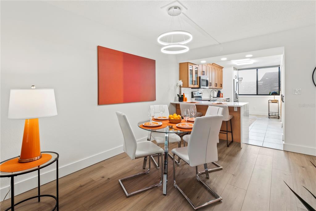 806 Bayport Way, Unit 806 Longboat Key, FL 34228 - Photo 17 of 79 a dining room with furniture and wooden floor