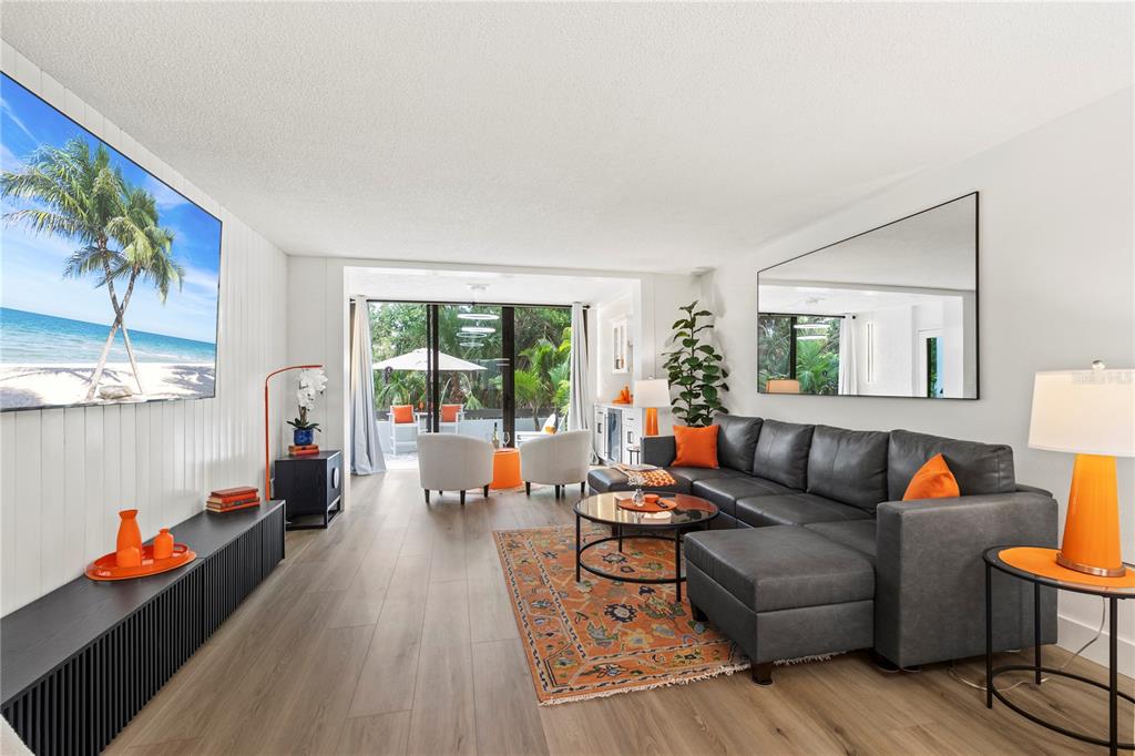 806 Bayport Way, Unit 806 Longboat Key, FL 34228 - Photo 22 of 79 a living room with furniture and a wooden floor