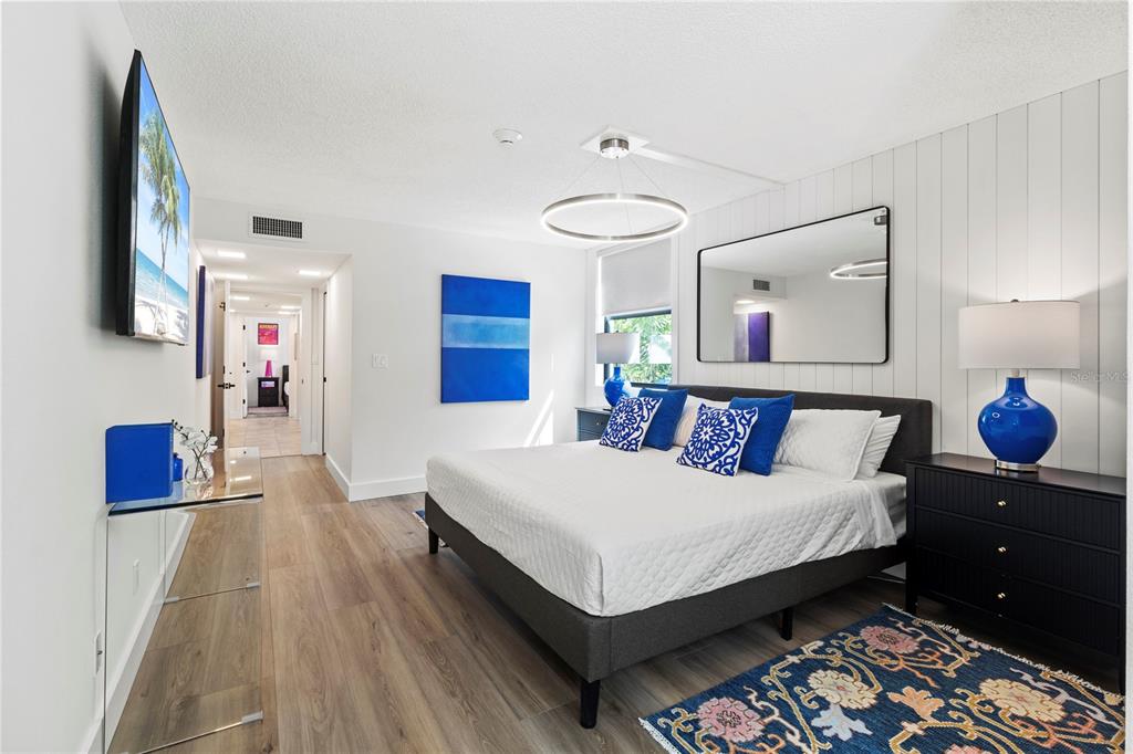 806 Bayport Way, Unit 806 Longboat Key, FL 34228 - Photo 27 of 79 a bedroom with a bed and a lamp on dresser