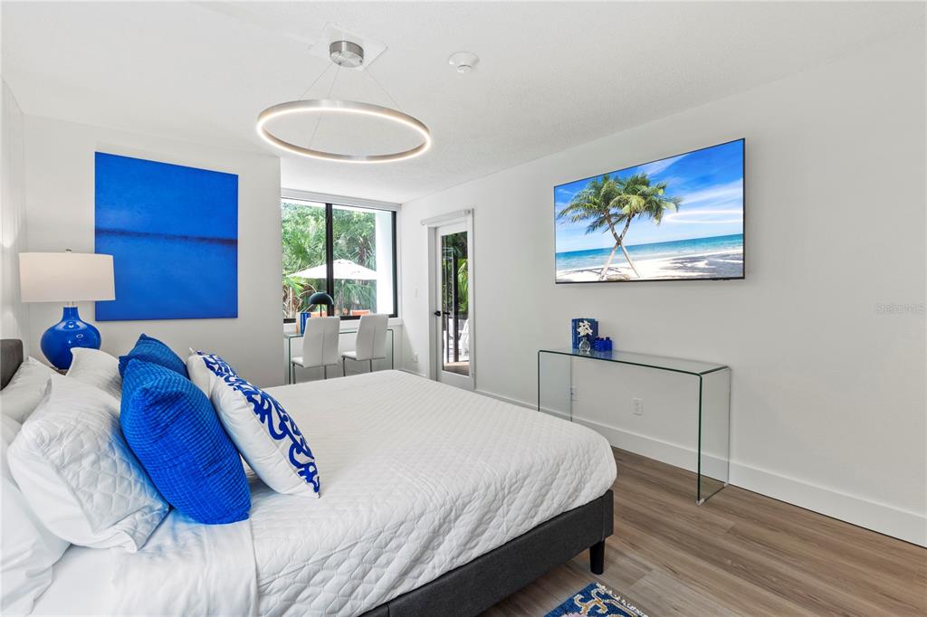 806 Bayport Way, Unit 806 Longboat Key, FL 34228 - Photo 28 of 79 a bedroom with a bed and a painting on the wall