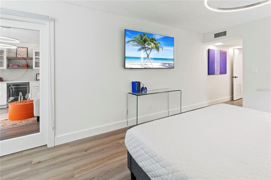 806 Bayport Way, Unit 806 Longboat Key, FL 34228 - Photo 30 of 79 a bedroom with a bed and a painting on the wall