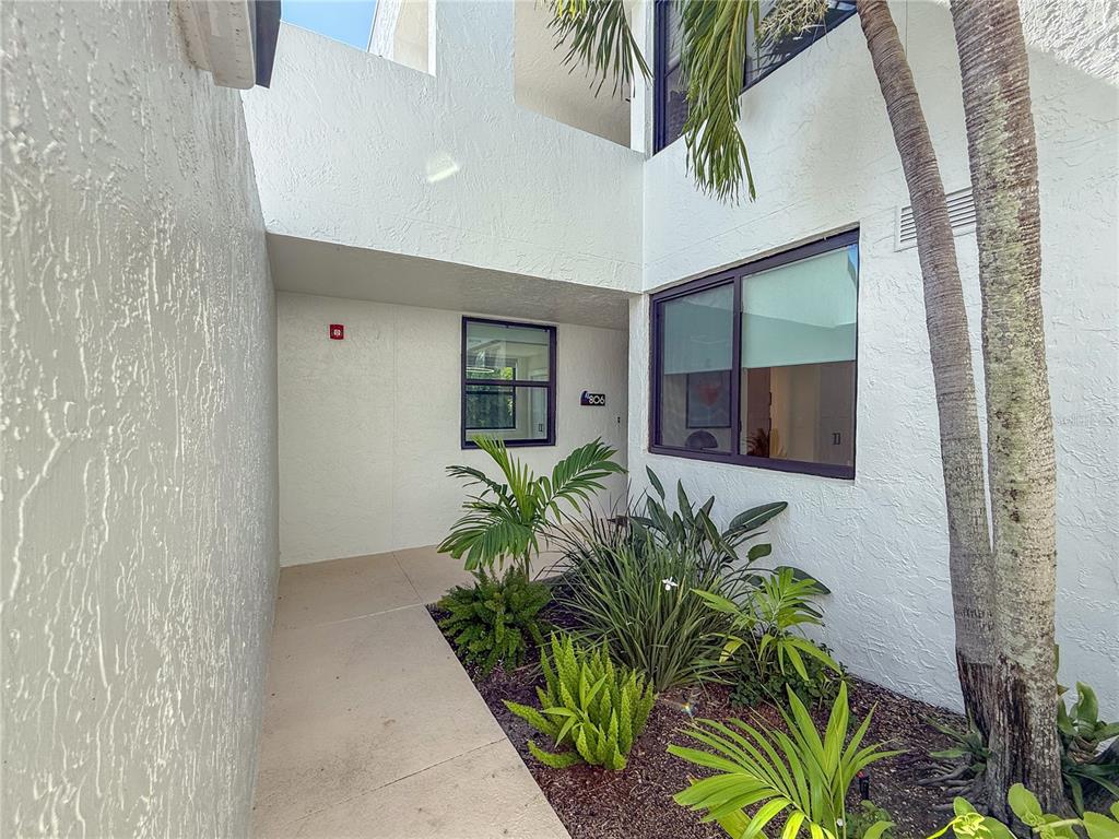 806 Bayport Way, Unit 806 Longboat Key, FL 34228 - Photo 3 of 79 a potted plant sitting in front of a door