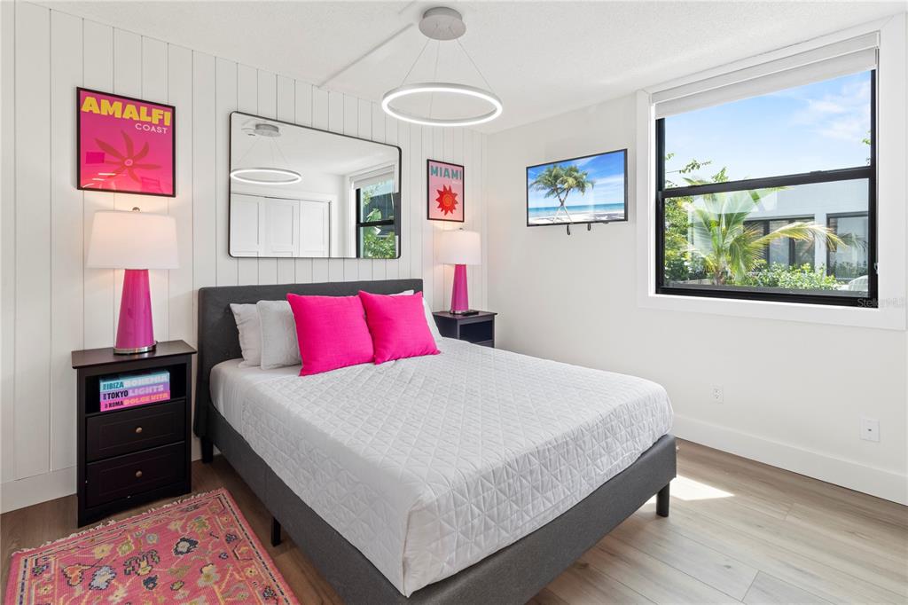 806 Bayport Way, Unit 806 Longboat Key, FL 34228 - Photo 34 of 79 a bedroom with a bed and a lamp on dresser