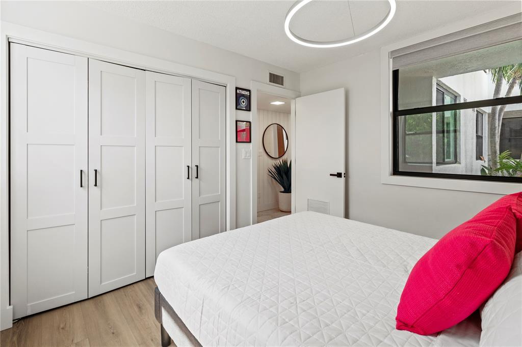 806 Bayport Way, Unit 806 Longboat Key, FL 34228 - Photo 36 of 79 a bedroom with a bed and a window