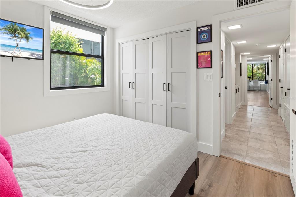 806 Bayport Way, Unit 806 Longboat Key, FL 34228 - Photo 37 of 79 a spacious bedroom with a bed and a window