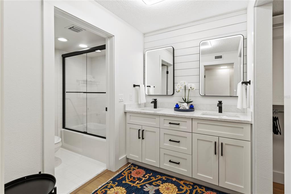 806 Bayport Way, Unit 806 Longboat Key, FL 34228 - Photo 39 of 79 a spacious bathroom with a double vanity sink a mirror and a