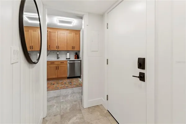 a kitchen with stainless steel appliances granite countertop a sink window and cabinets