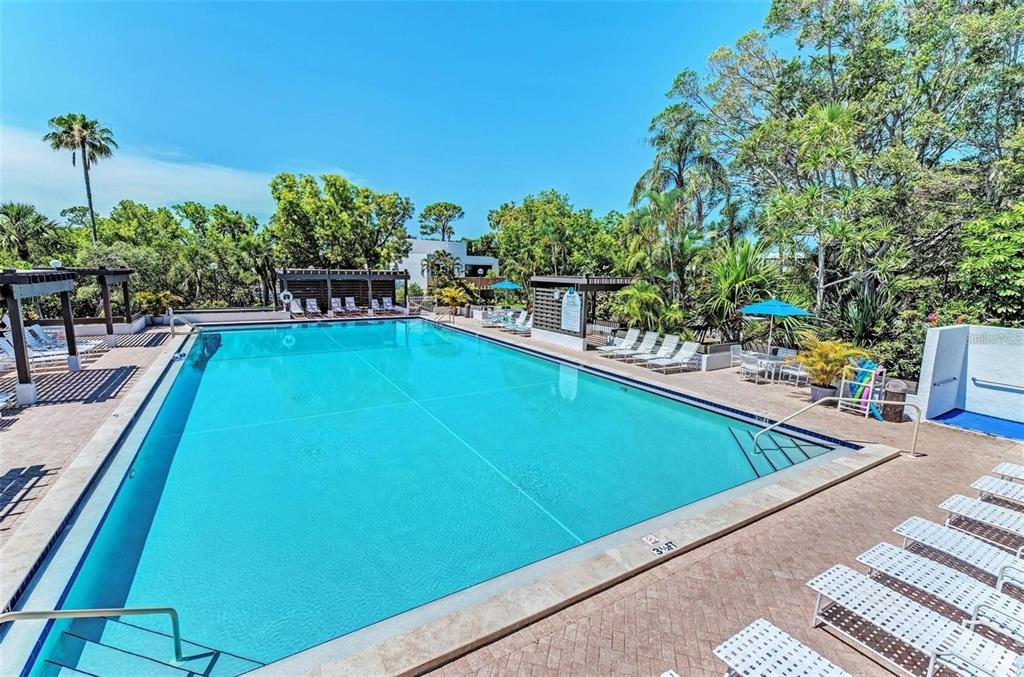 806 Bayport Way, Unit 806 Longboat Key, FL 34228 - Photo 57 of 79 a view of a swimming pool with a patio and a yard