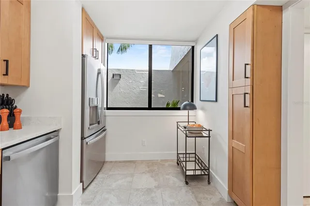 a living room with furniture and a dining table