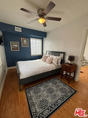 a bed sitting in a bedroom and view of living room
