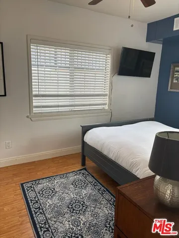 a bedroom with a bed and a television