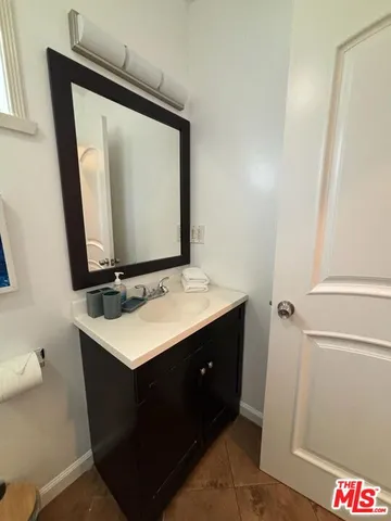 a bathroom with a sink vanity and a mirror