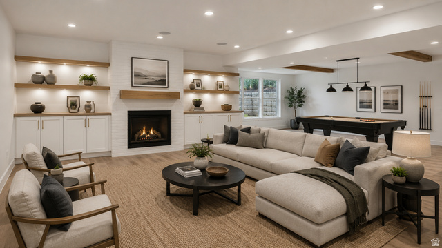 1682 North 1950 W Street, Unit 9 Provo, UT 84604 - Photo 74 of 84 Spacious entertainment area featuring a white brick fireplace with a wood mantel, built-in cabinetry with illuminated shelving, and wood-finish flooring