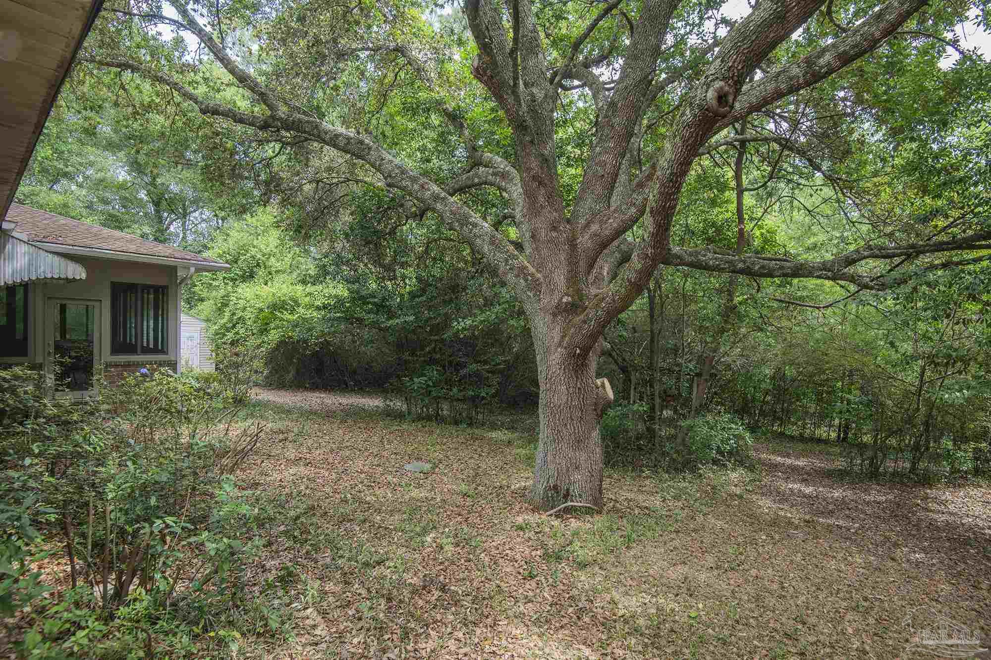 1210 Goldenrod Road Cantonment, FL 32533 - Photo 46 of 50 a view of a house with large trees