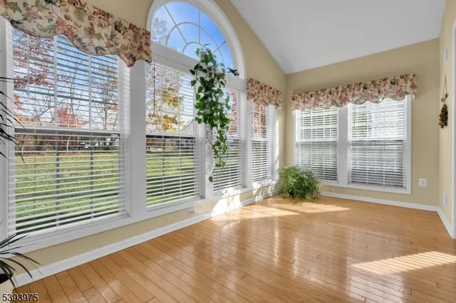 a view of porch with a floor to ceiling window and potted plants