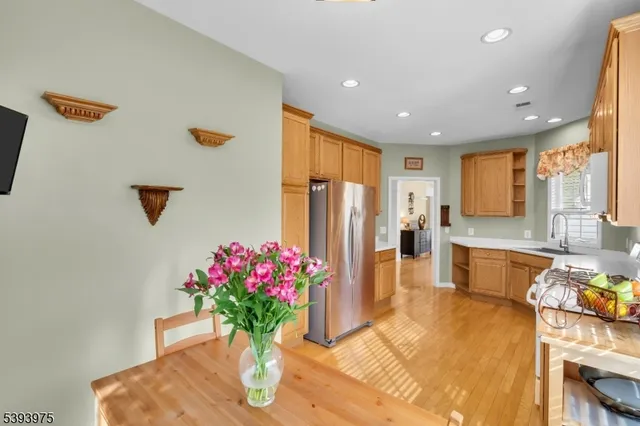 a kitchen with stainless steel appliances granite countertop a refrigerator and a sink