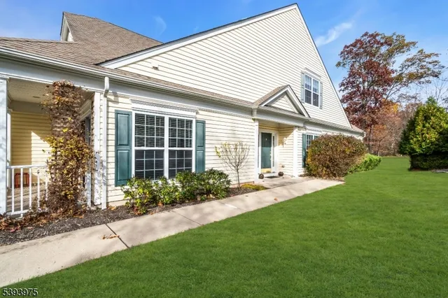 a front view of a house with a yard and outdoor seating