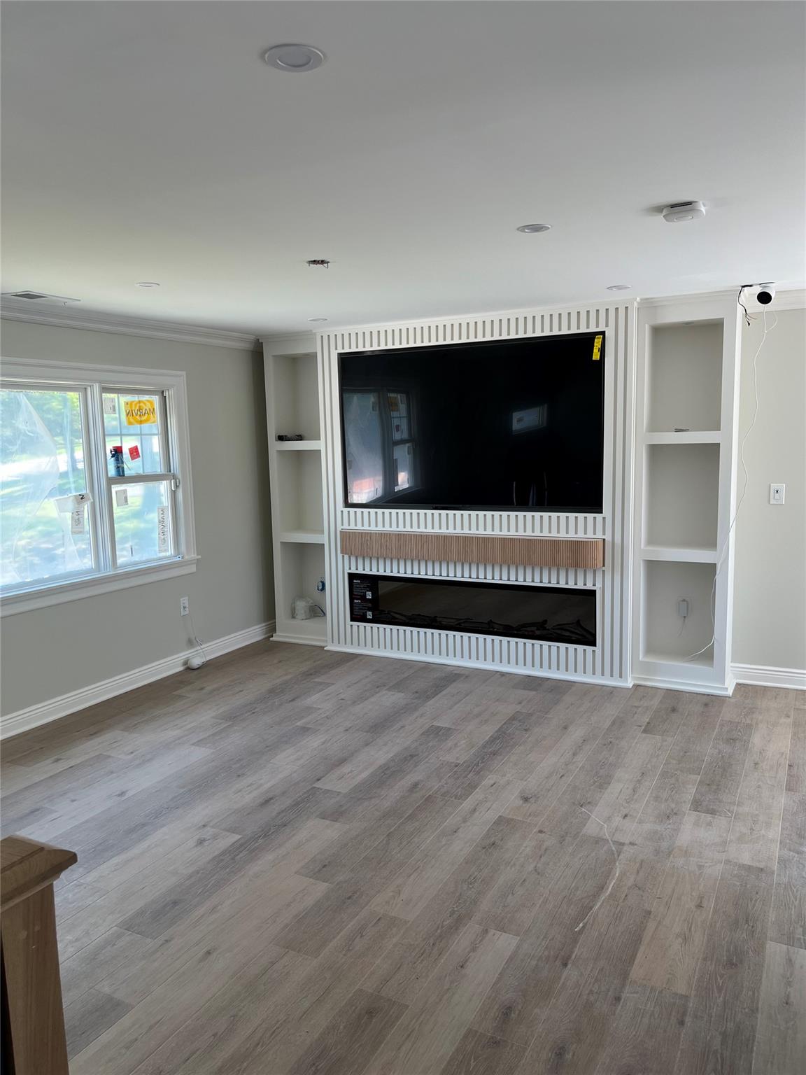 4 Glen Court Poughkeepsie, NY 12603 - Photo 4 of 32 a view of an empty room with a window and wooden floor