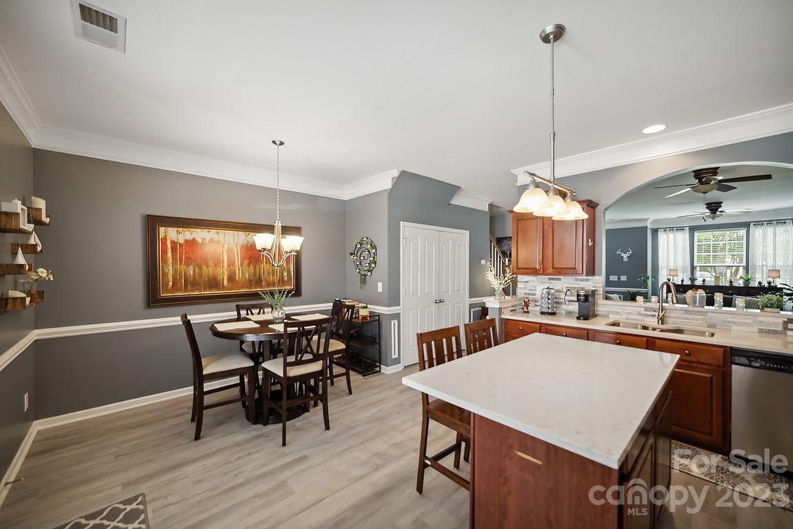 9526 Inglenook Lane Huntersville, NC 28078 - Photo 11 of 20 a view of a dining room and livingroom with furniture wooden floor a chandelier