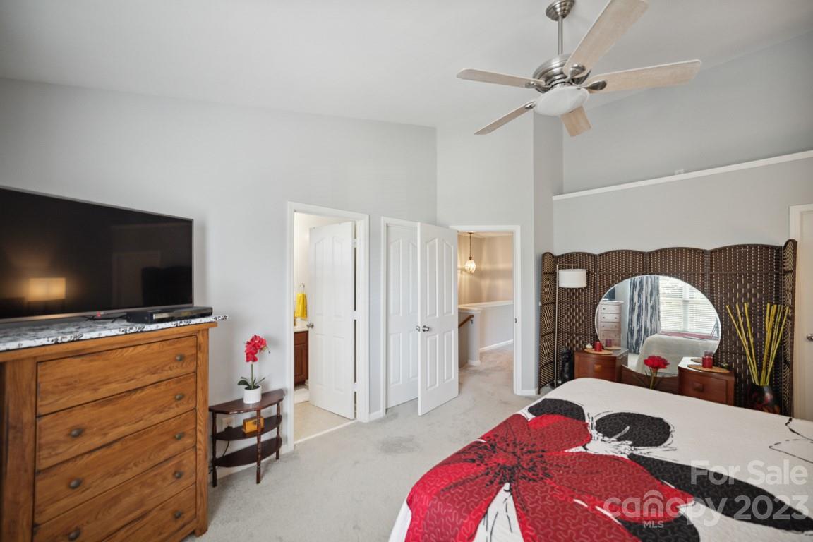 9526 Inglenook Lane Huntersville, NC 28078 - Photo 13 of 20 a bedroom with a bed and a flat screen tv