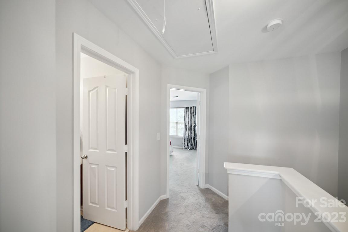 9526 Inglenook Lane Huntersville, NC 28078 - Photo 14 of 20 a view of a hallway with closet and mirror