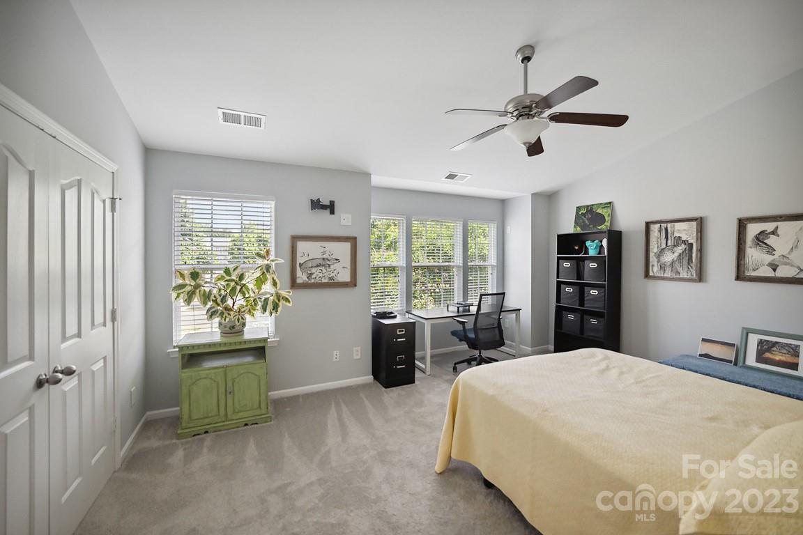 9526 Inglenook Lane Huntersville, NC 28078 - Photo 16 of 20 a bed room with a bed and a chandelier