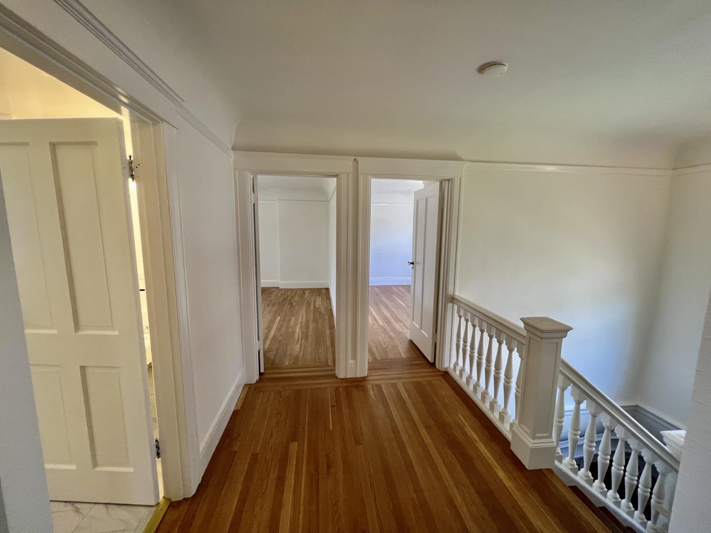 1616 Adeline Drive Burlingame, CA 94010 - Photo 16 of 31 a view of a hallway with wooden floor and staircase