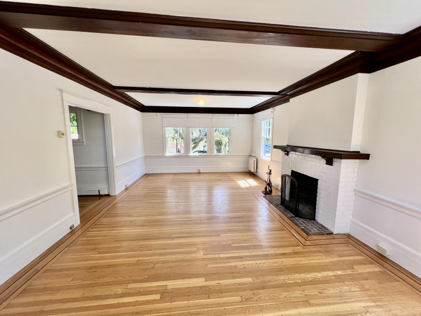 1616 Adeline Drive Burlingame, CA 94010 - Photo 26 of 31 a view of an empty room with wooden floor fireplace and a window