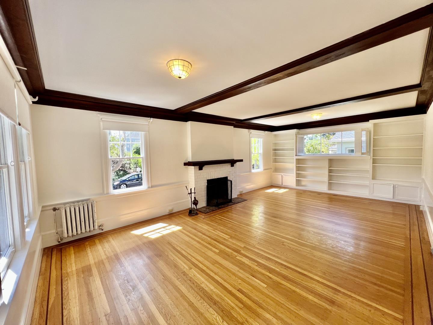 1616 Adeline Drive Burlingame, CA 94010 - Photo 27 of 31 a view of empty room with wooden floor and fireplace
