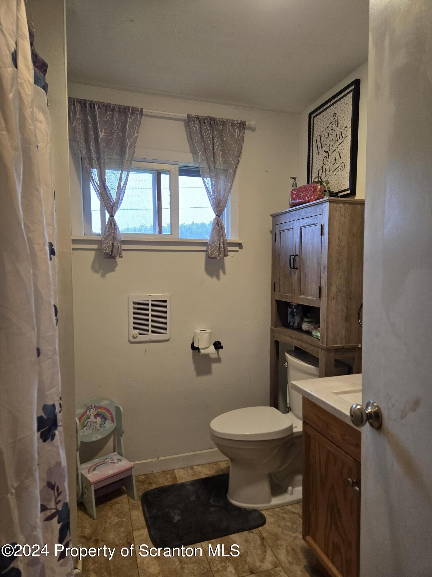 1609 State Rte 3005 Meshoppen, PA 18630 - Photo 11 of 18 a bathroom with a toilet a sink and a window