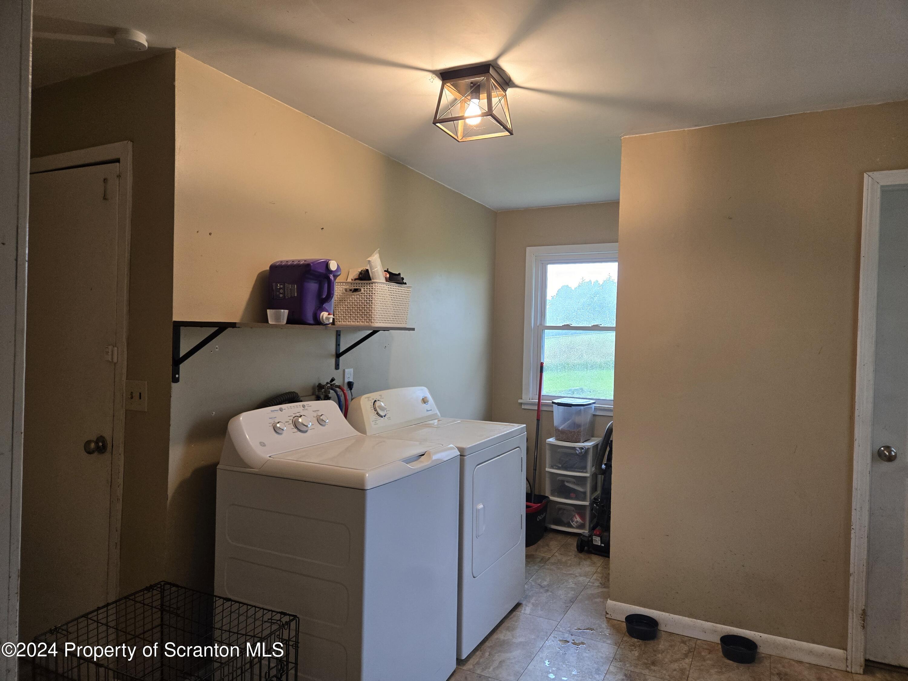 1609 State Rte 3005 Meshoppen, PA 18630 - Photo 5 of 18 a utility room with a sink dryer and washer