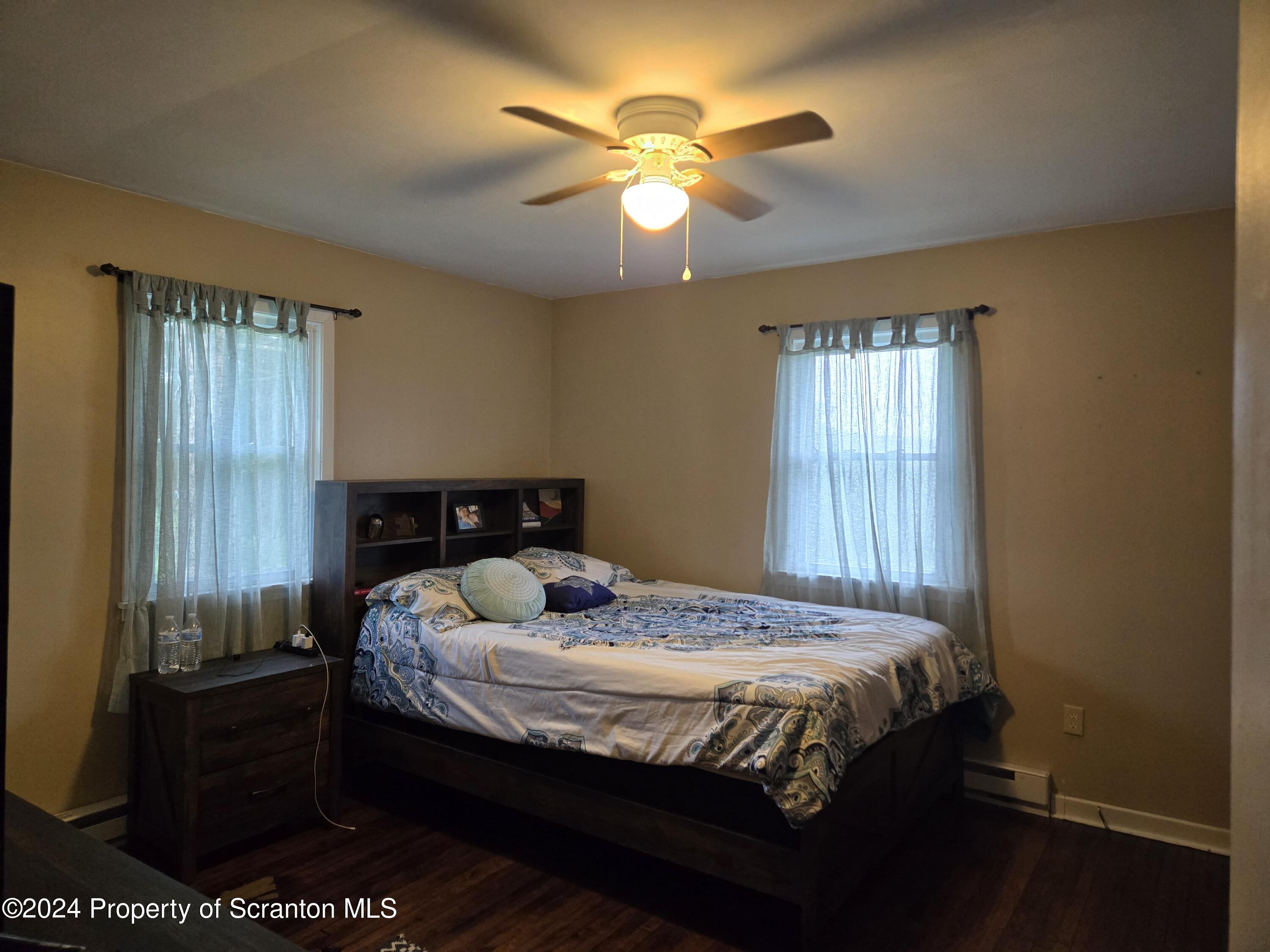1609 State Rte 3005 Meshoppen, PA 18630 - Photo 6 of 18 a bed sitting in a bedroom next to a window