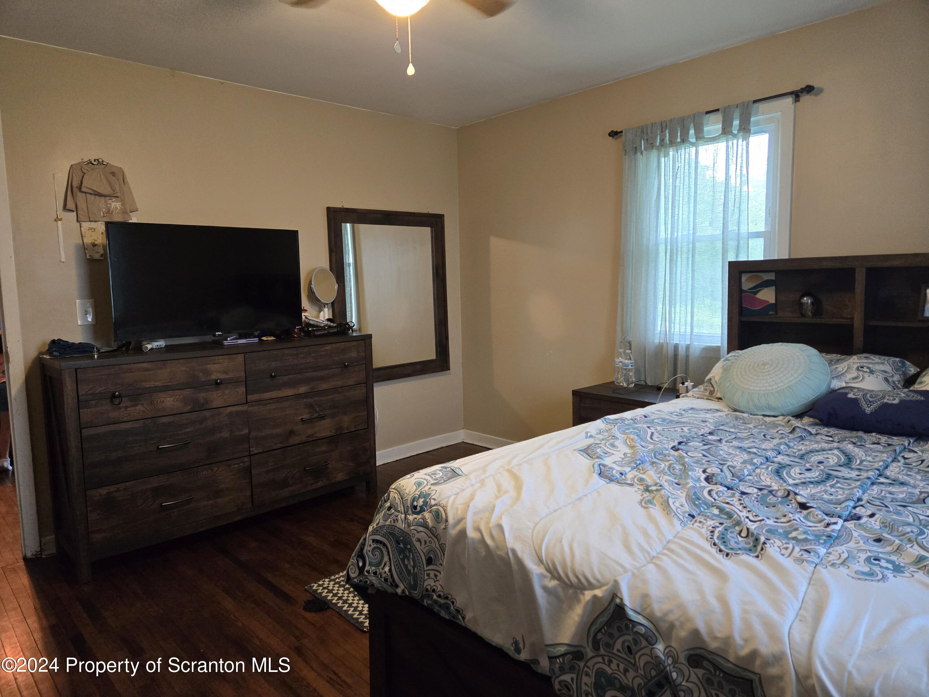 1609 State Rte 3005 Meshoppen, PA 18630 - Photo 7 of 18 a bedroom with a bed and a flat screen tv