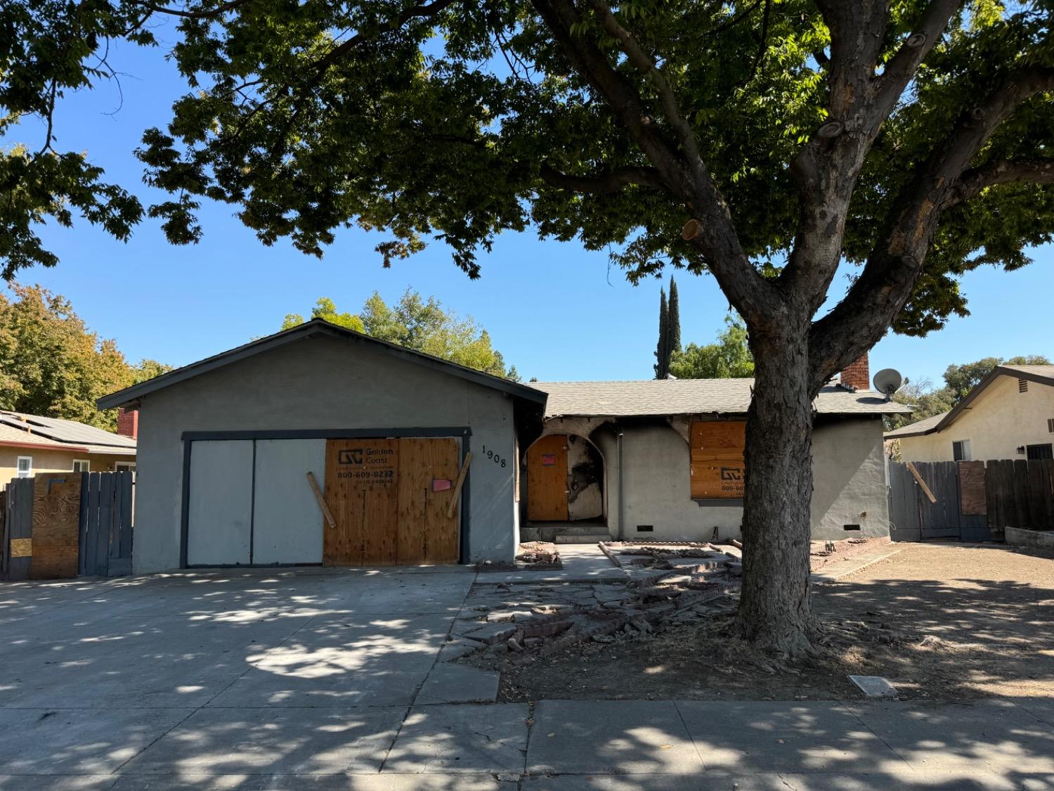 a view of a house with a tree in front of it