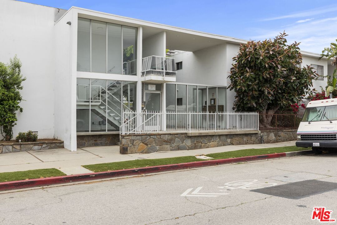 1295 Federal Avenue, Unit 8 Los Angeles, CA 90025 - Photo 2 of 12 a house with trees in the background