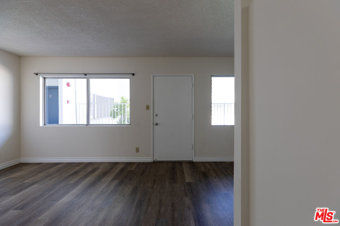 1295 Federal Avenue, Unit 8 Los Angeles, CA 90025 - Photo 3 of 12 an empty room with wooden floor and windows