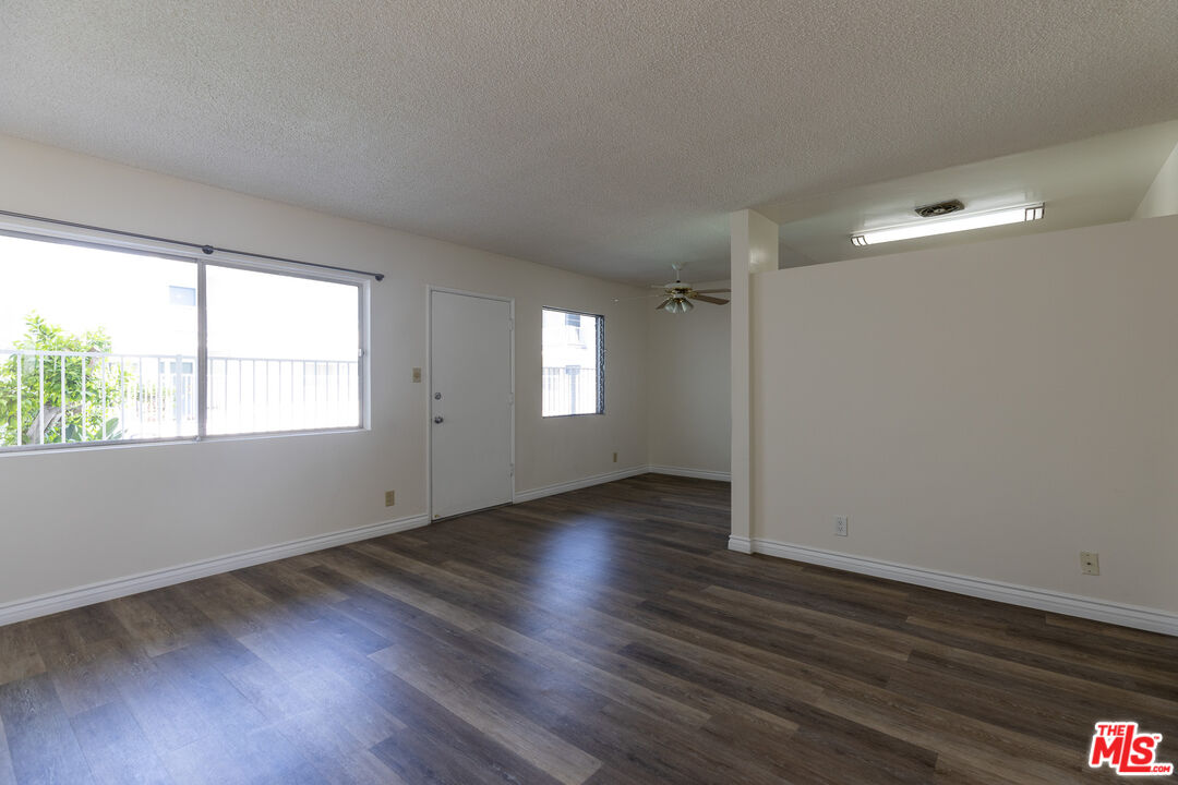 1295 Federal Avenue, Unit 8 Los Angeles, CA 90025 - Photo 4 of 12 an empty room with wooden floor and windows