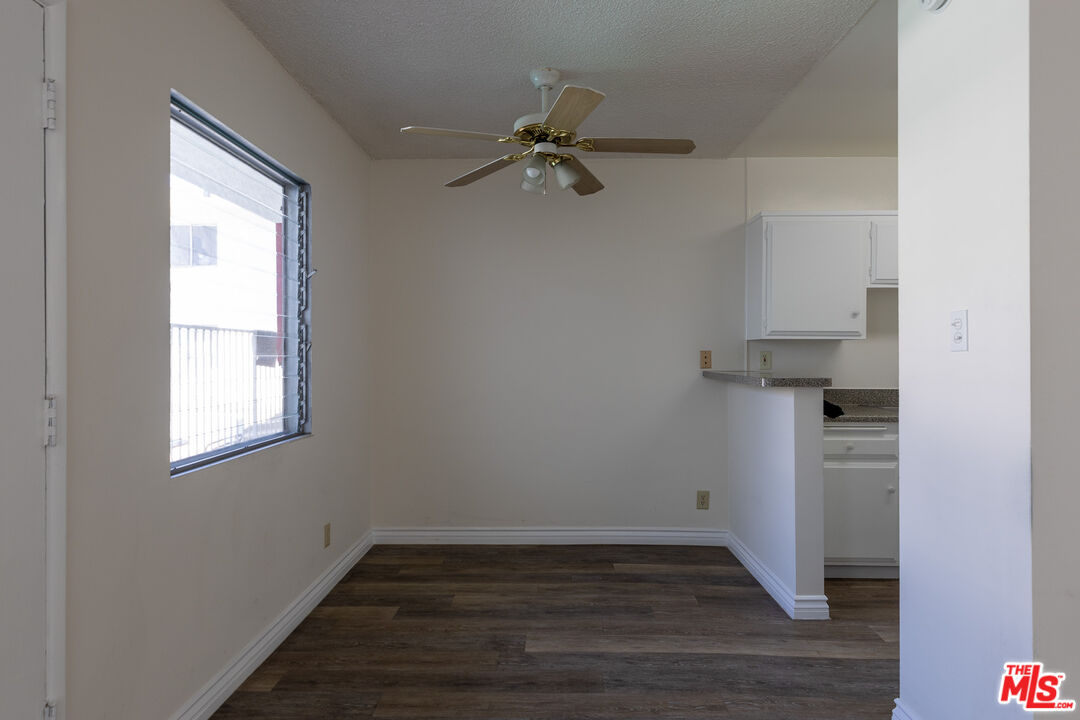 1295 Federal Avenue, Unit 8 Los Angeles, CA 90025 - Photo 5 of 12 an empty room with wooden floor cabinet and windows