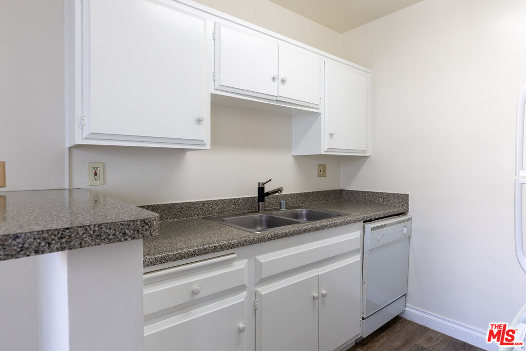 1295 Federal Avenue, Unit 8 Los Angeles, CA 90025 - Photo 7 of 12 a kitchen with granite countertop white cabinets and a sink