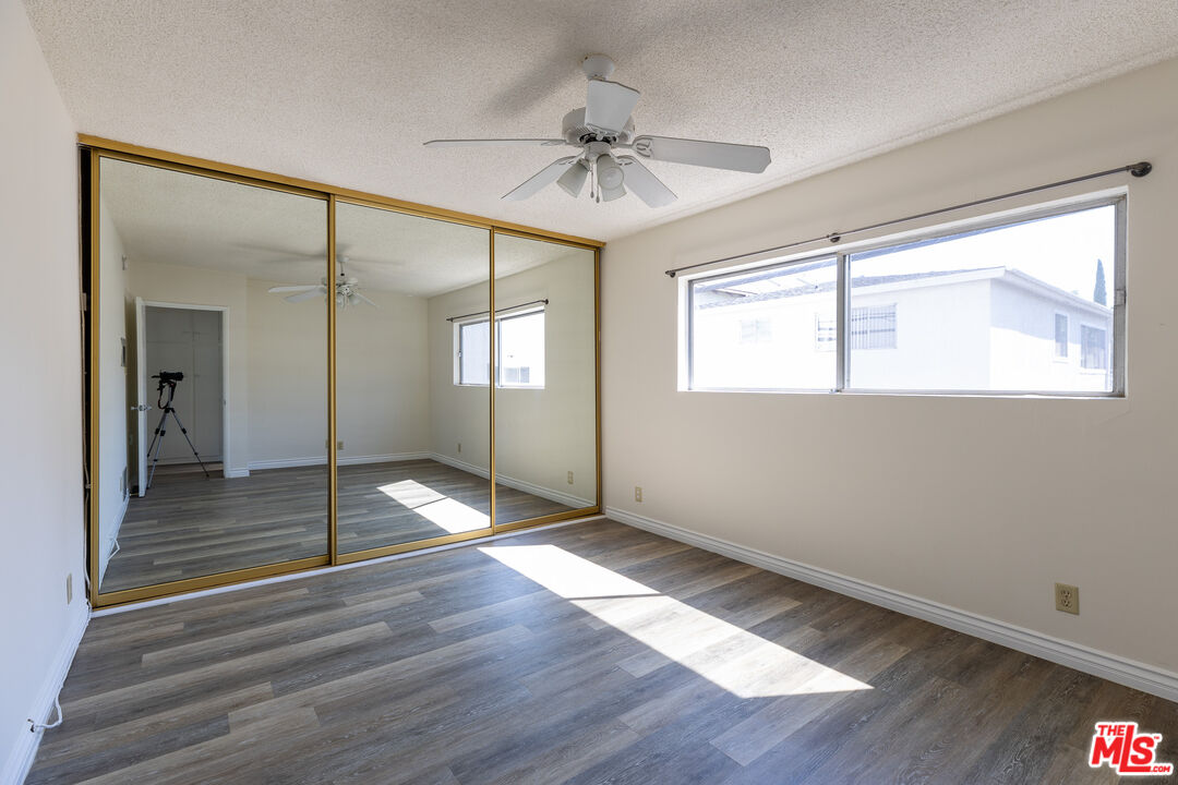 1295 Federal Avenue, Unit 8 Los Angeles, CA 90025 - Photo 10 of 12 wooden floor in an empty room with a window