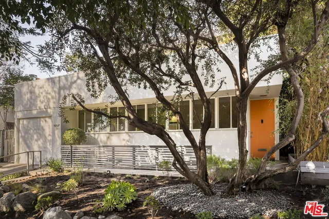 a view of a house with a tree