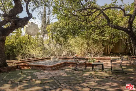 a backyard of a house with table and chairs