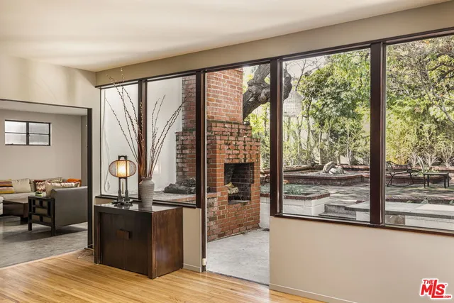 a view of a living room and kitchen with a large window