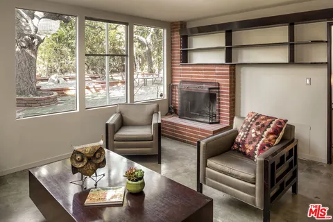 a living room with furniture wooden floor and a fireplace