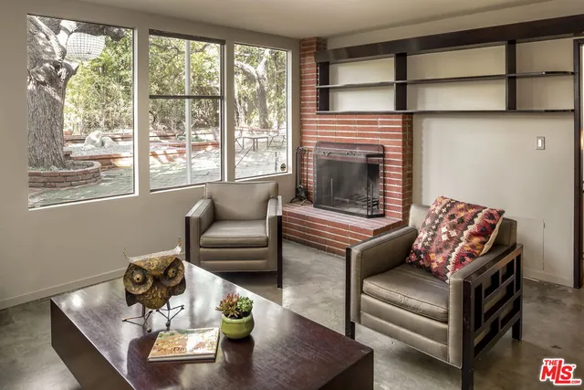 a living room with furniture wooden floor and a fireplace