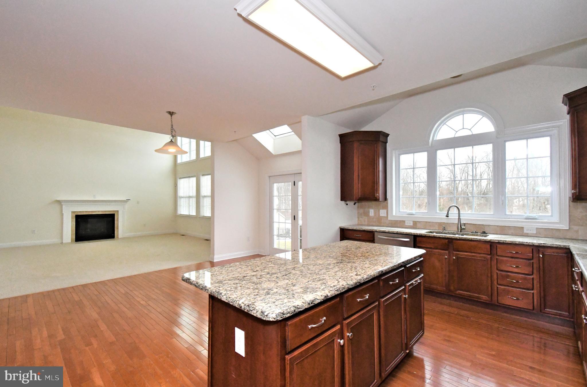 2804 Hoffs Way Warrington, PA 18976 - Photo 11 of 63 a kitchen with granite countertop a sink cabinets and wooden floor