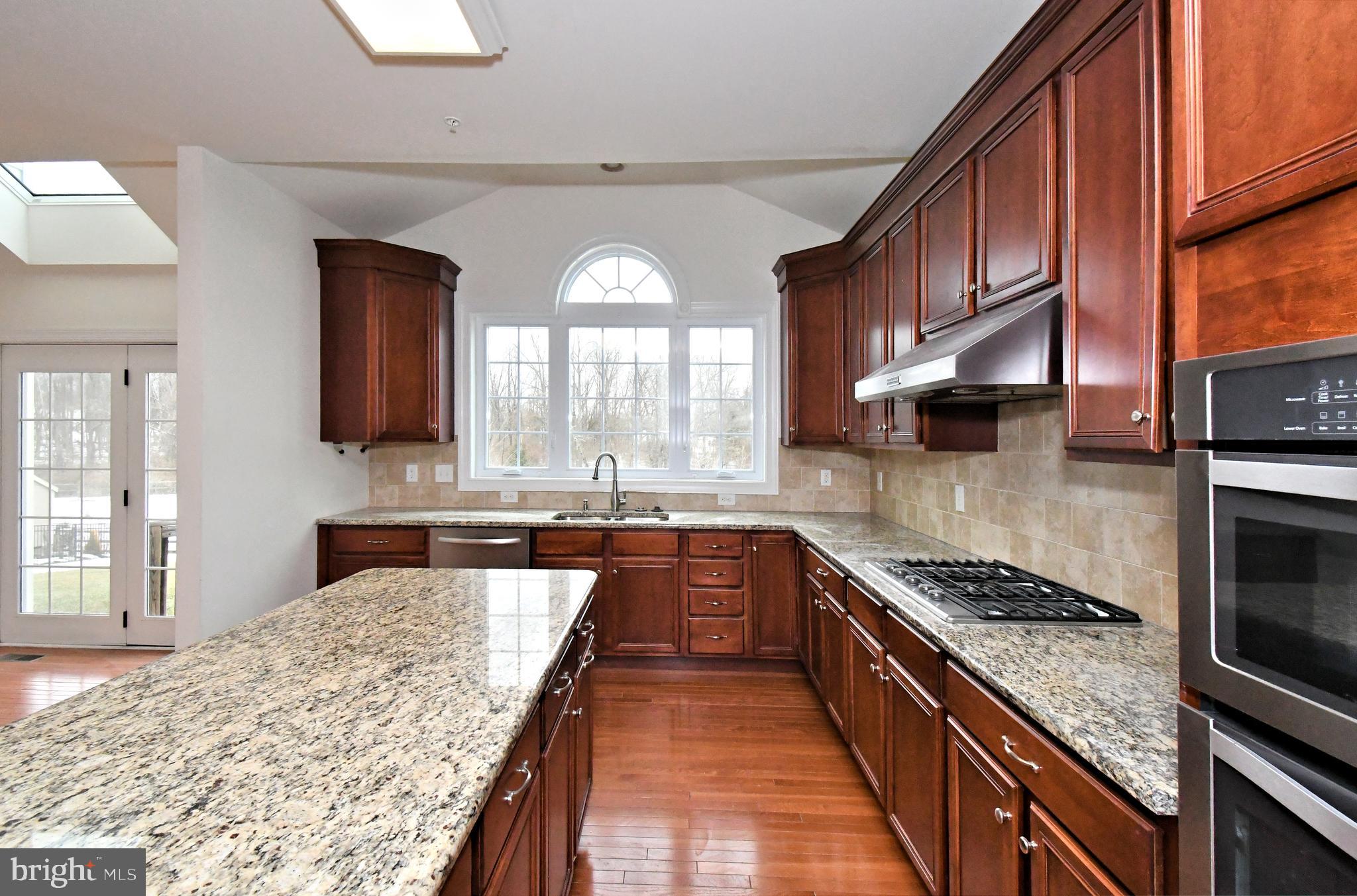 2804 Hoffs Way Warrington, PA 18976 - Photo 12 of 63 a large kitchen with stainless steel appliances granite countertop a stove and a sink