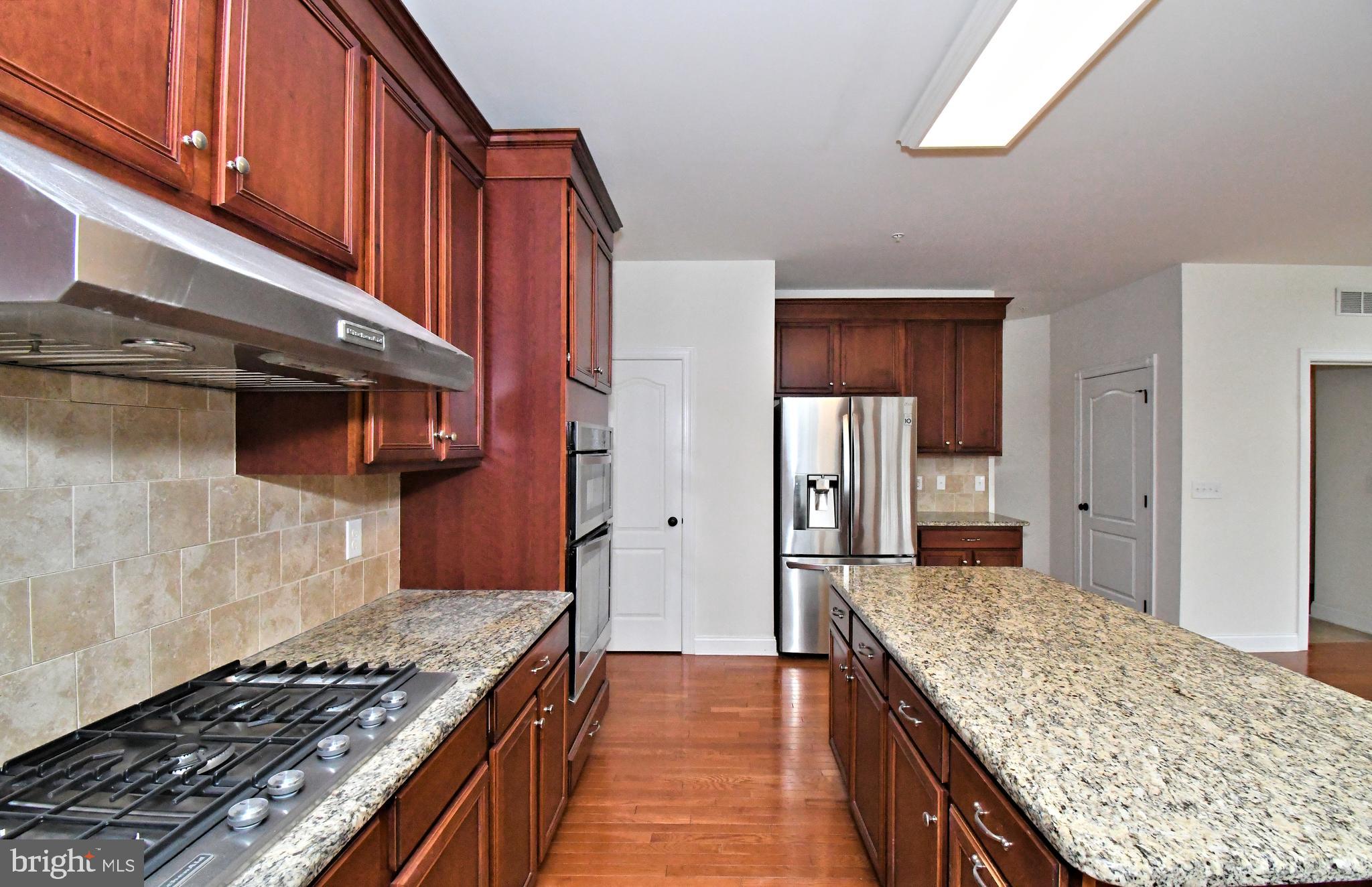 2804 Hoffs Way Warrington, PA 18976 - Photo 14 of 63 a kitchen with granite countertop stainless steel appliances and wooden cabinets