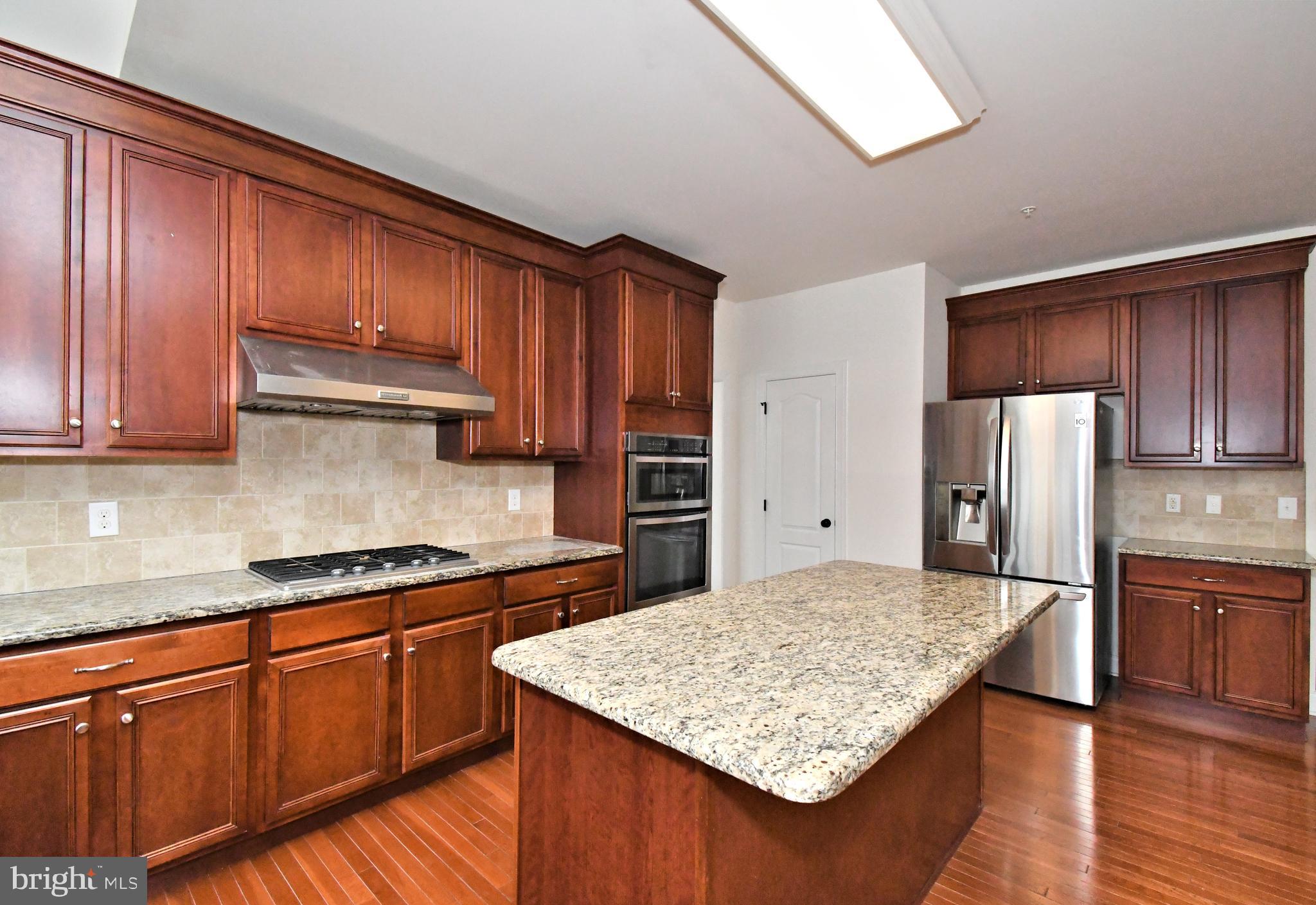 2804 Hoffs Way Warrington, PA 18976 - Photo 15 of 63 a kitchen with stainless steel appliances granite countertop refrigerator sink and cabinets